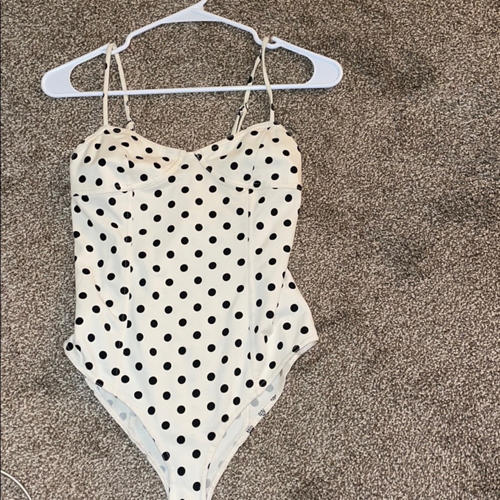 Cream bodysuit with black dots.